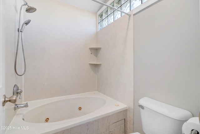 bathroom featuring toilet and tiled shower / bath