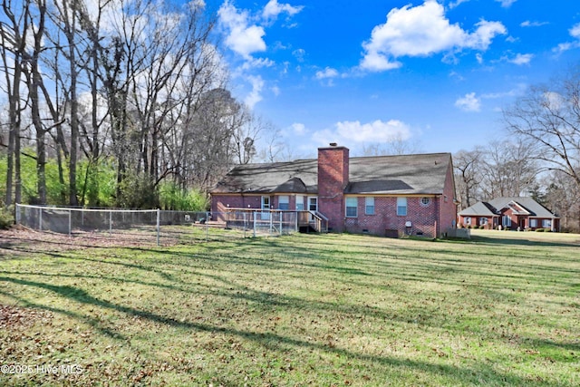 back of property featuring a lawn