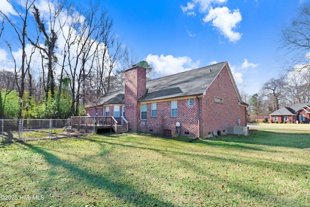 back of property featuring a deck, a yard, and central air condition unit