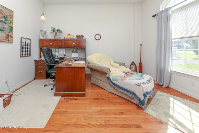 office space with light wood-style floors and baseboards