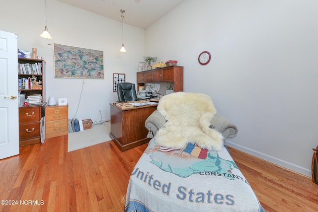 office with lofted ceiling, light wood finished floors, and baseboards