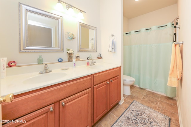 bathroom with double vanity, a shower with curtain, toilet, and a sink