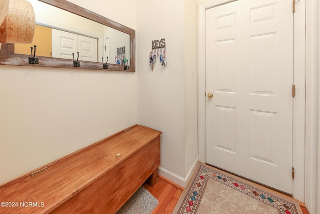 doorway with baseboards and light wood-style floors