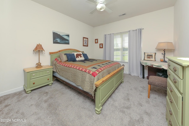 bedroom with light carpet, baseboards, visible vents, and a ceiling fan