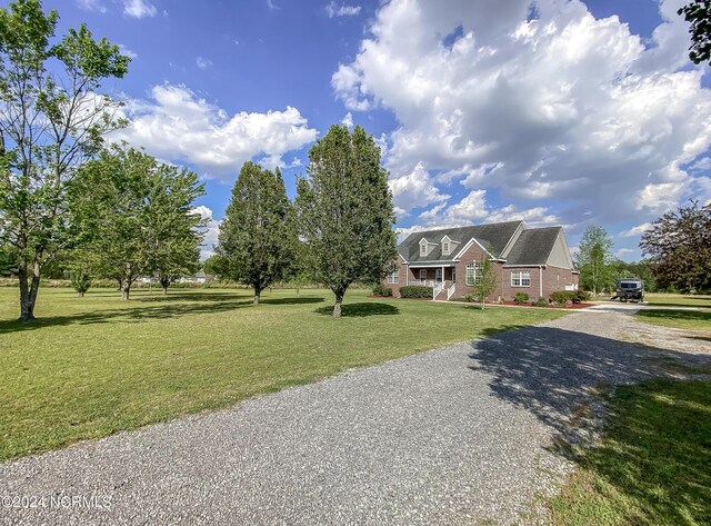 view of front of house with covered porch and a front lawn