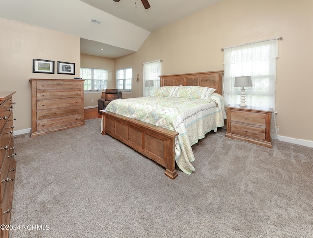 bedroom featuring lofted ceiling, baseboards, visible vents, and light colored carpet