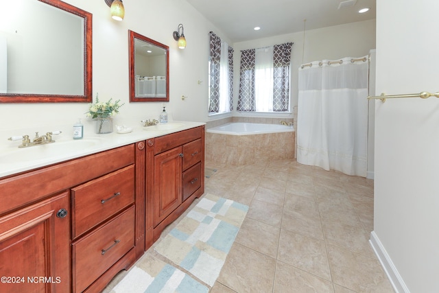 bathroom with tile patterned flooring, a garden tub, a sink, and double vanity