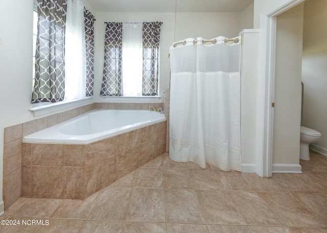 bathroom with toilet, a garden tub, and tile patterned floors