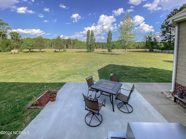 view of patio with fence and outdoor dining area