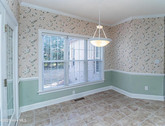 unfurnished dining area with tile patterned floors and crown molding