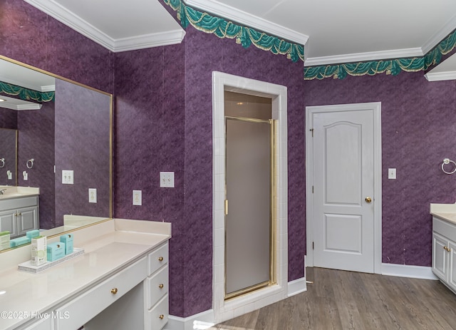 bathroom featuring hardwood / wood-style floors, a shower with shower door, and ornamental molding