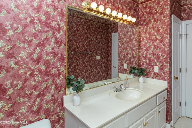 bathroom with tile patterned flooring and vanity