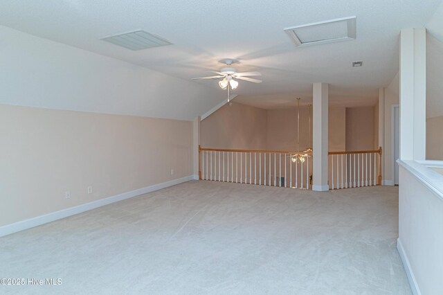 additional living space with ceiling fan, light colored carpet, and vaulted ceiling