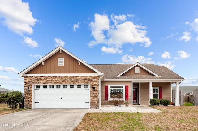 craftsman house with a garage and a front lawn