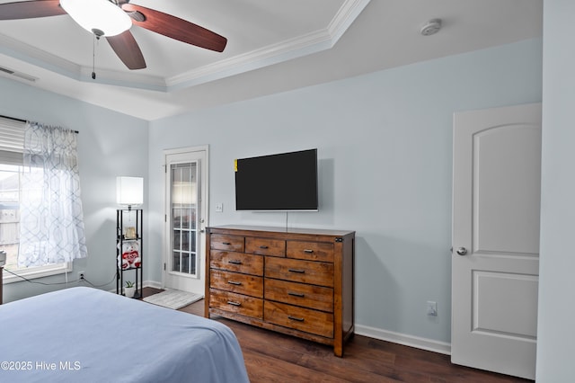 bedroom featuring a raised ceiling, ornamental molding, dark hardwood / wood-style floors, and ceiling fan