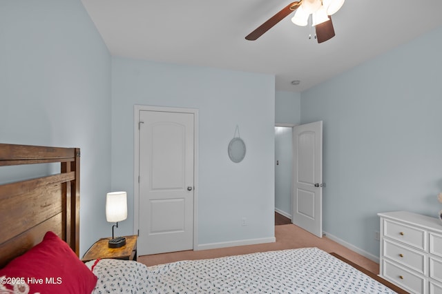 bedroom featuring light colored carpet and ceiling fan