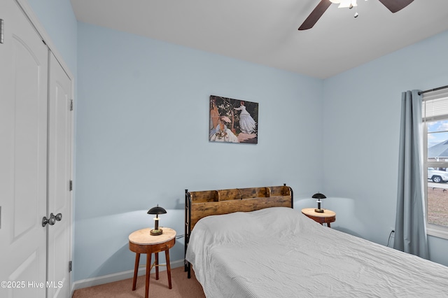 carpeted bedroom with ceiling fan and a closet