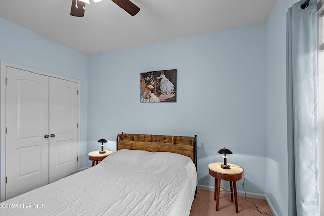 carpeted bedroom with ceiling fan and a closet