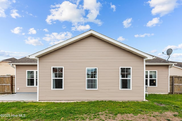 rear view of property with a patio area and a lawn