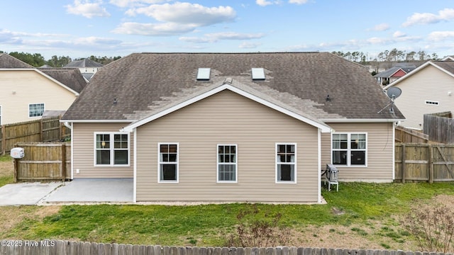 rear view of property featuring a lawn and a patio