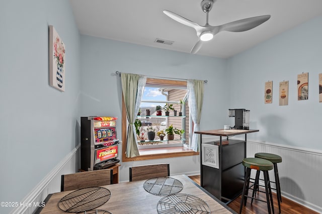 dining area with hardwood / wood-style flooring and ceiling fan