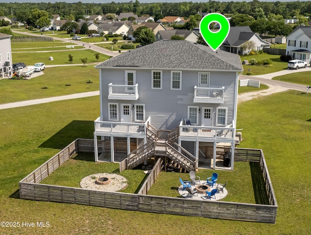 back of house featuring a deck, a patio, a balcony, and an outdoor fire pit