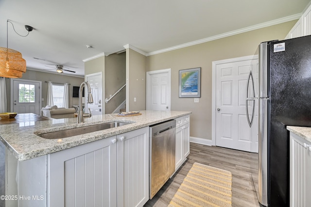 kitchen featuring ornamental molding, appliances with stainless steel finishes, sink, and white cabinets