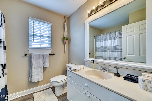 bathroom featuring vanity, hardwood / wood-style floors, and toilet