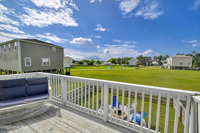 wooden deck with outdoor lounge area and a lawn