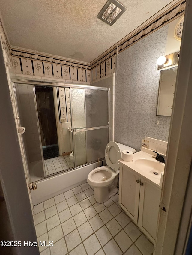 full bathroom with toilet, vanity, tile patterned flooring, enclosed tub / shower combo, and a textured ceiling