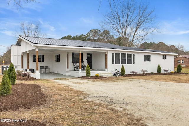 view of front of property featuring a carport and covered porch