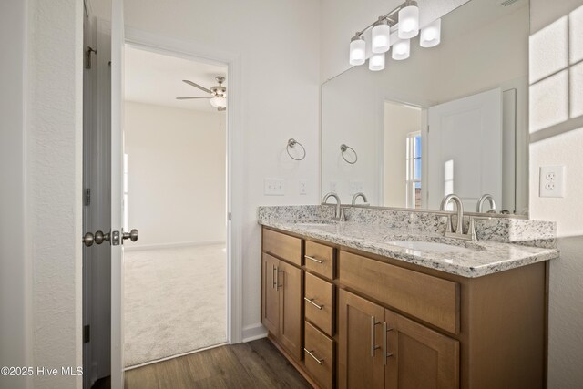 bathroom featuring vanity, hardwood / wood-style flooring, and ceiling fan