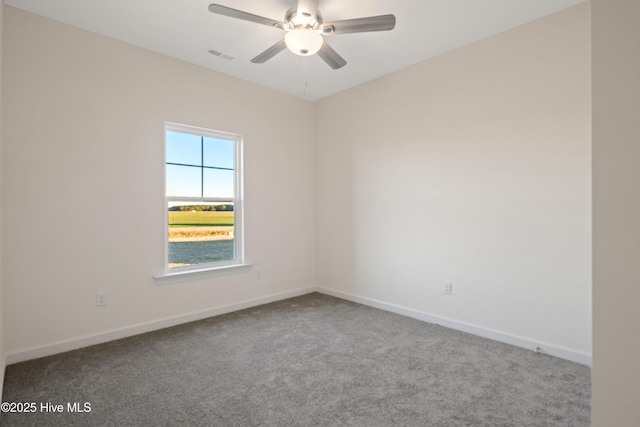 spare room featuring carpet and ceiling fan