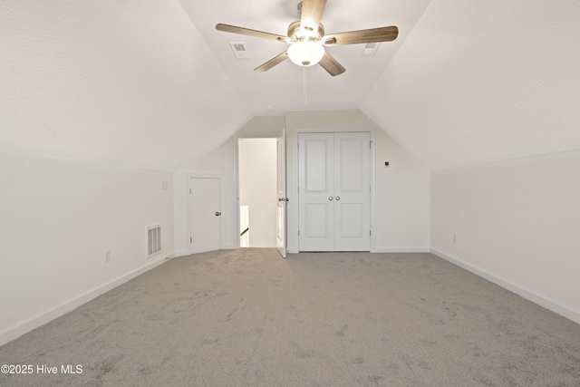 additional living space with ceiling fan, carpet, and vaulted ceiling