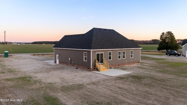 view of back house at dusk