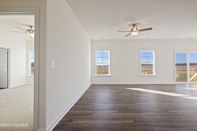 unfurnished room featuring ceiling fan and dark hardwood / wood-style flooring