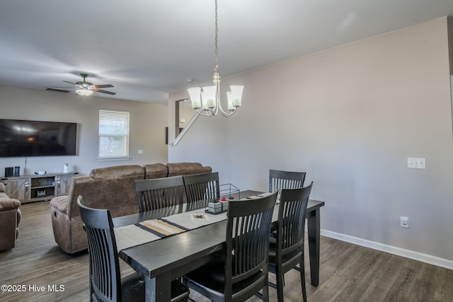 dining room with hardwood / wood-style floors and ceiling fan with notable chandelier