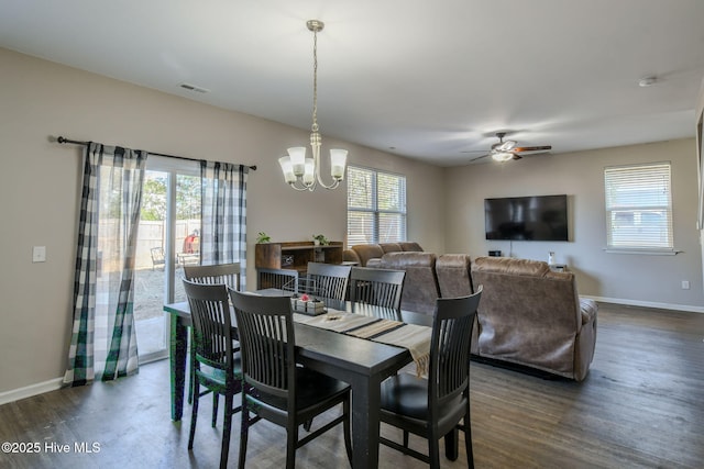 dining space with plenty of natural light, dark hardwood / wood-style flooring, and ceiling fan with notable chandelier