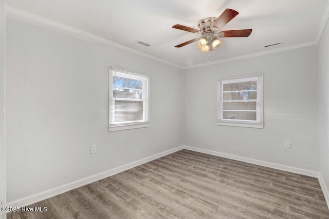 spare room featuring hardwood / wood-style flooring, ornamental molding, and ceiling fan