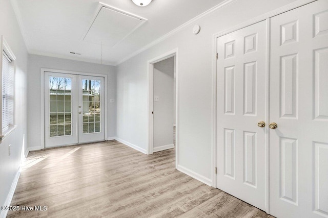 spare room with french doors, ornamental molding, and light hardwood / wood-style flooring