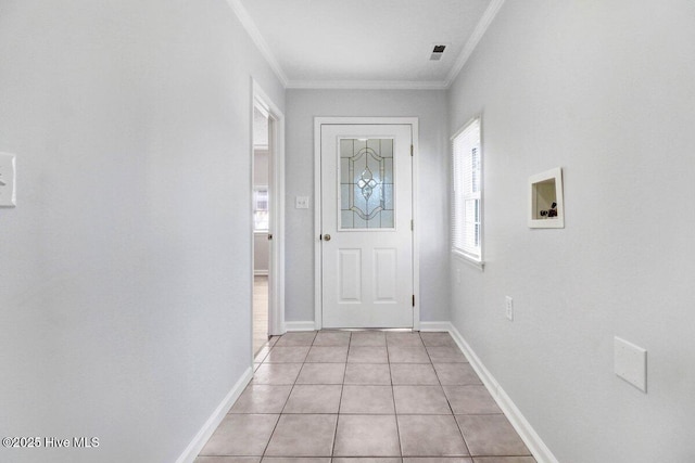 doorway to outside featuring crown molding and light tile patterned flooring