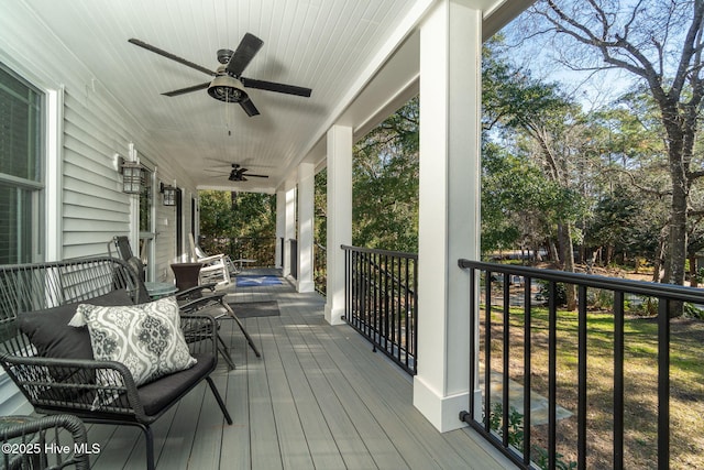 deck with ceiling fan and a porch