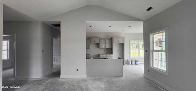 2040 Bluewater Blvd, New Bern, NC 28562 - kitchen with vaulted ceiling, concrete floors, and gray cabinets