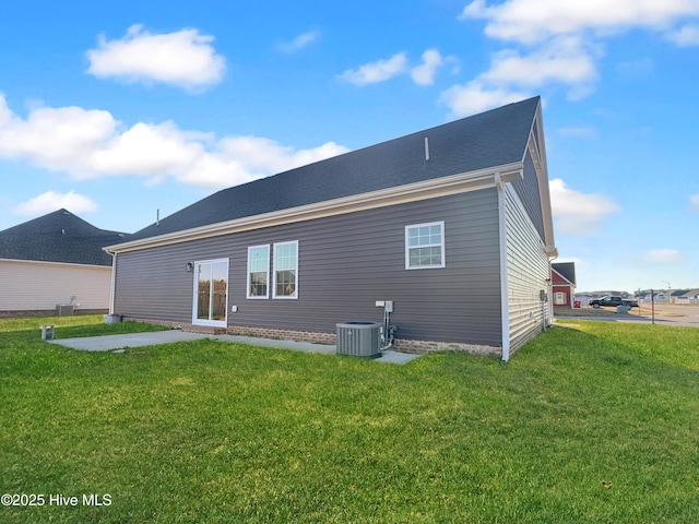 rear view of house featuring a yard and central AC