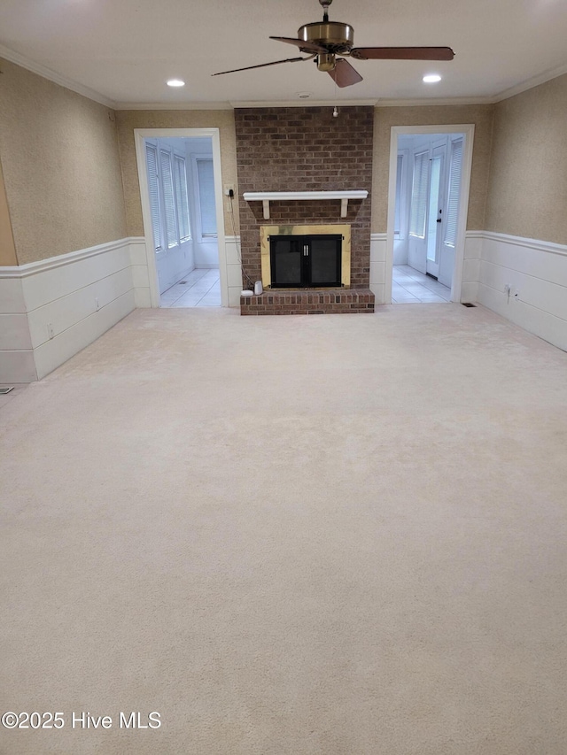 unfurnished living room with crown molding, light carpet, and a brick fireplace