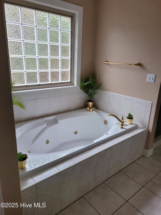 bathroom with tile patterned floors and tiled tub