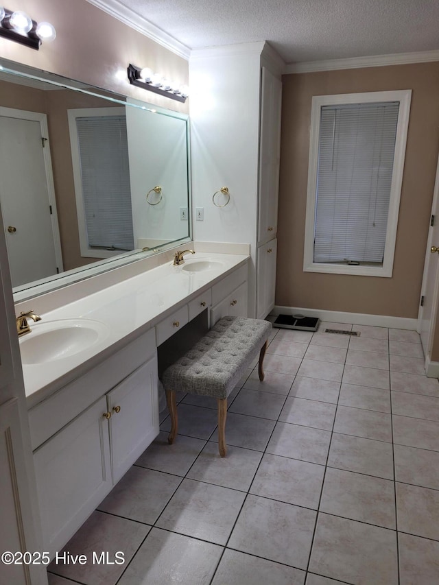 bathroom with tile patterned flooring, vanity, a textured ceiling, and ornamental molding