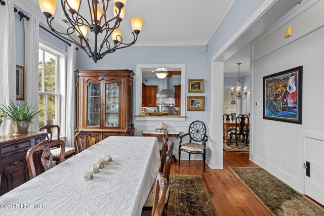 living room with light hardwood / wood-style floors and crown molding