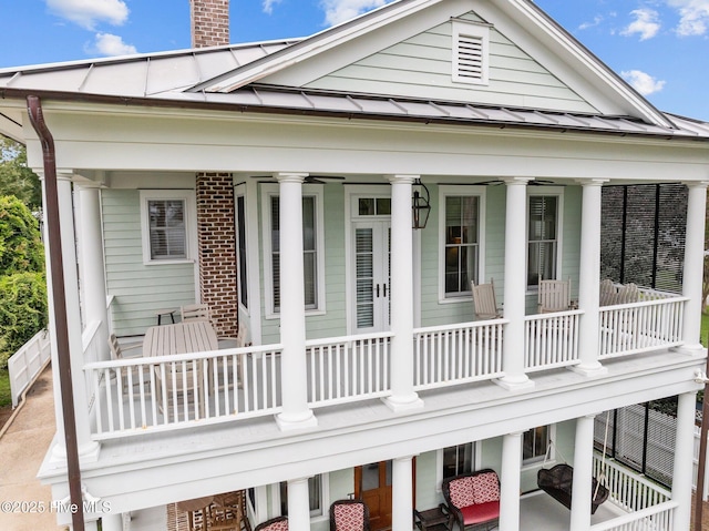 back of house with a balcony and a porch