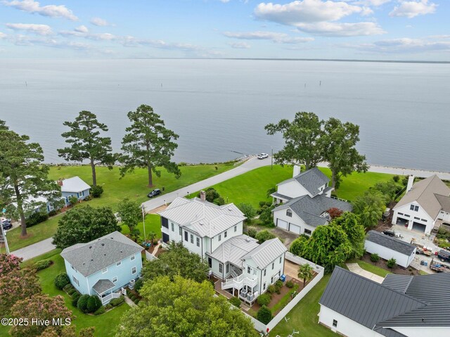 birds eye view of property with a water view